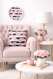 Pink armchair with floral pillow, coffee table with flowers and decor items in a cozy living room.